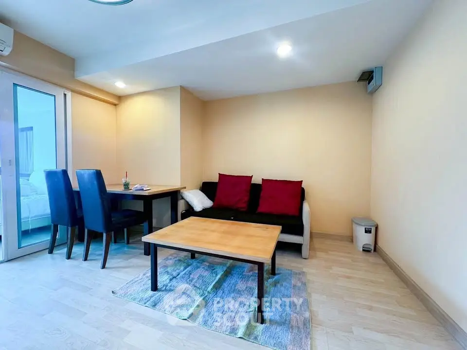 Modern living room with cozy seating and dining area, featuring stylish decor and natural light.