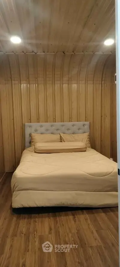 Cozy bedroom with wooden walls and modern lighting