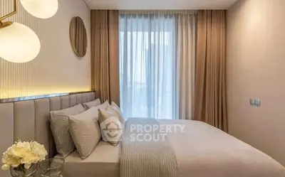 Luxurious bedroom with elegant decor and large window for natural light.