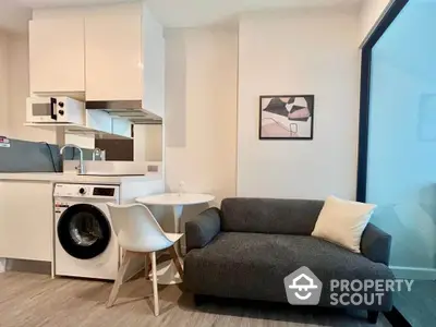 Modern compact living room with integrated kitchen and washing machine