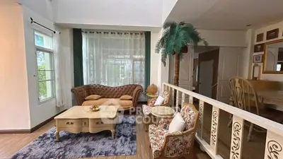 Spacious living room with elegant furniture and large windows for natural light.