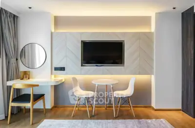 Modern living room with stylish furniture and wall-mounted TV