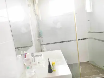 Modern bathroom with sleek fixtures and glass shower enclosure