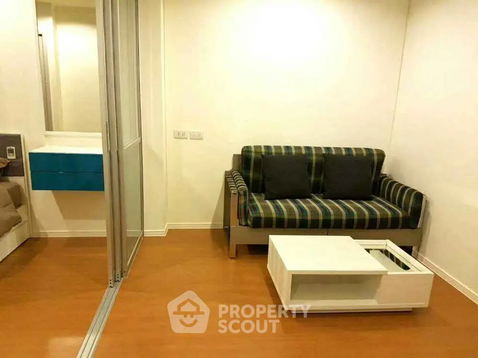 Cozy living room with modern sofa and sleek coffee table in a stylish apartment.