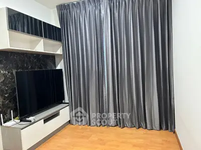 Modern living room with sleek TV setup and elegant curtains