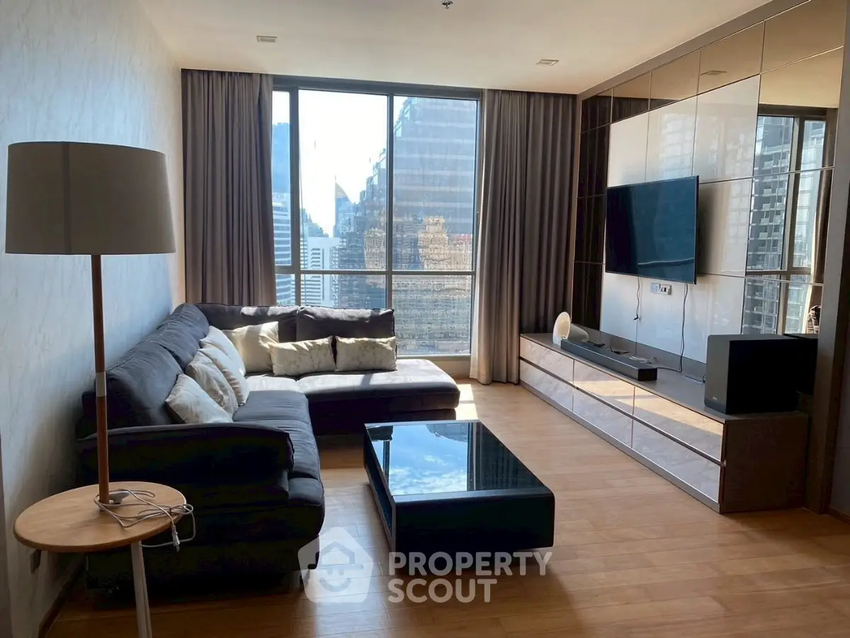 Modern living room with city view, stylish furniture, and large windows.