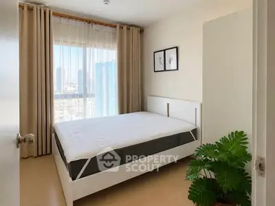 Bright bedroom with city view, modern decor, and large window for natural light.
