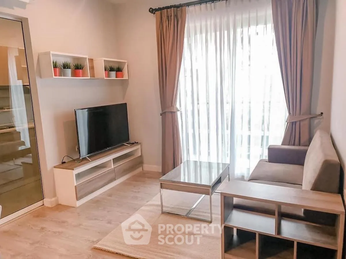 Modern living room with natural light, stylish furniture, and elegant decor.