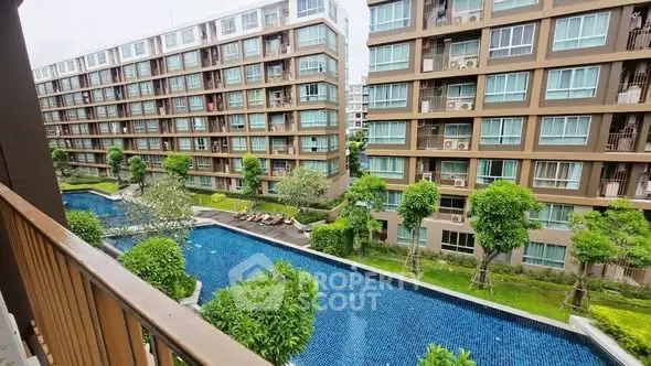 Modern apartment complex with pool view and lush greenery