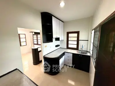 Modern kitchen with sleek black and white cabinetry and open layout