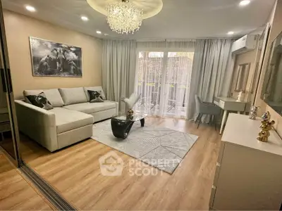 Elegant living room with modern decor, large sofa, and balcony access, perfect for relaxation and entertaining.