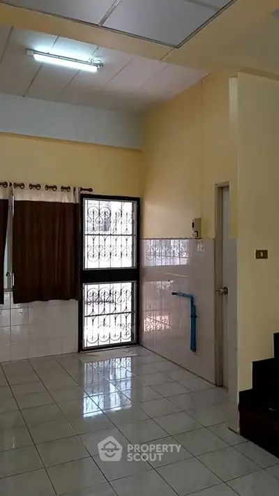 Spacious interior with tiled floors and large window, perfect for customization.