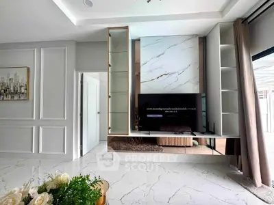 Modern living room with sleek marble accents and stylish built-in TV unit, offering a luxurious ambiance.