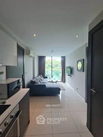 Modern living room with sleek kitchen and balcony view in stylish apartment
