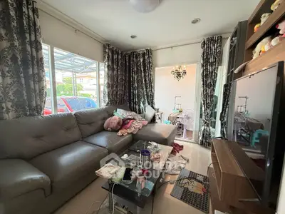 Cozy living room with large sofa and natural light, perfect for relaxation.