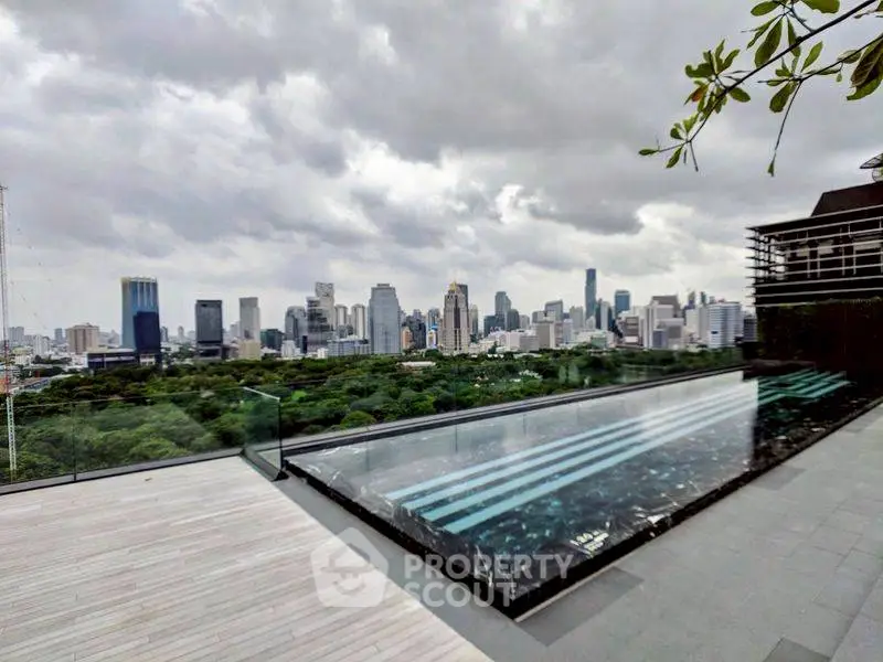 Luxurious rooftop pool with stunning city skyline view, perfect for urban living enthusiasts.