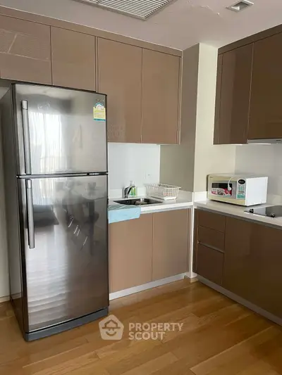 Modern kitchen with sleek cabinets and stainless steel fridge