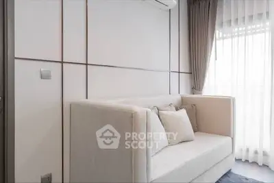 Modern living room with elegant sofa and large window with curtains