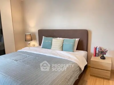 Cozy bedroom with modern decor and stylish bedding in a well-lit space.
