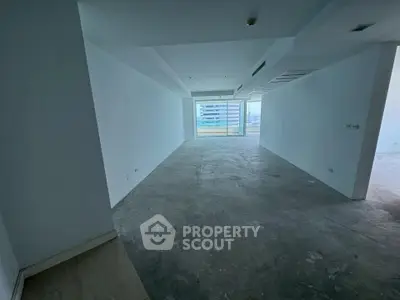 Spacious unfurnished apartment interior with large windows and city view, ideal for customization.
