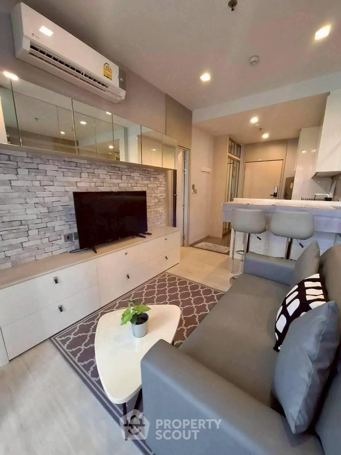 Modern living room with stylish decor and open kitchen layout in a cozy apartment.