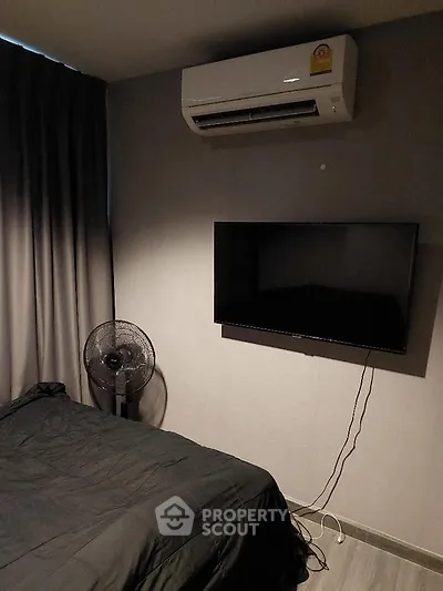 Modern bedroom with air conditioning and wall-mounted TV