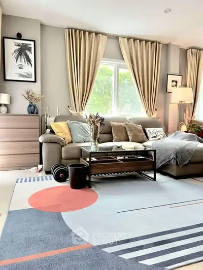 Stylish living room with modern decor, large sofa, and abstract rug.