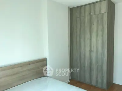 Modern bedroom with minimalist design and wooden wardrobe