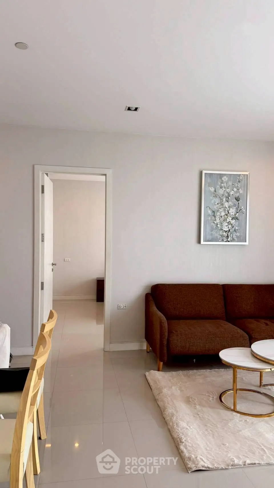 Modern living room with stylish brown sofa and elegant decor in a bright apartment.