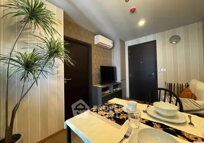 Cozy living room with modern decor and dining area in stylish apartment.