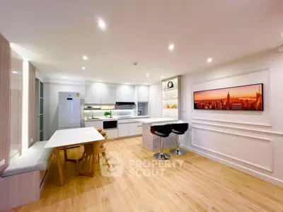 Modern kitchen with sleek design, open layout, and stylish dining area in a bright, spacious apartment.