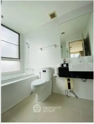 Modern bathroom with sleek fixtures and large window for natural light