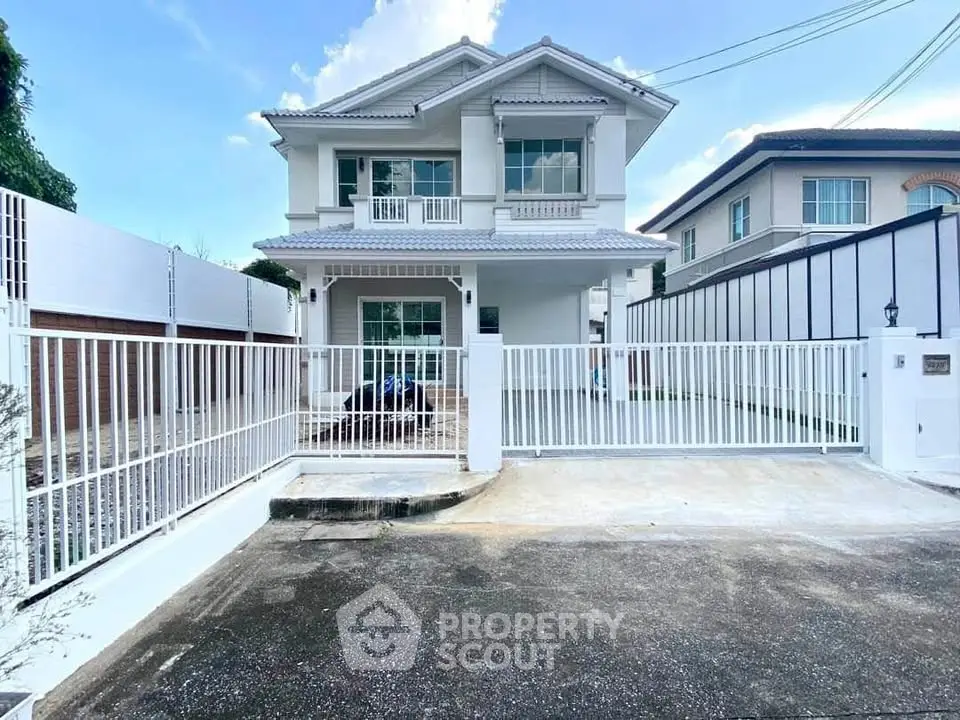 Charming two-story house with spacious driveway and modern design.