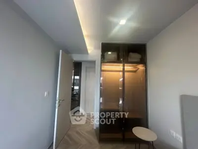Modern bedroom with sleek wardrobe and stylish lighting in a contemporary apartment.