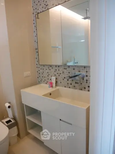 Modern bathroom with sleek sink and mosaic tile backsplash