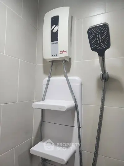 Modern bathroom with electric shower and sleek tile design