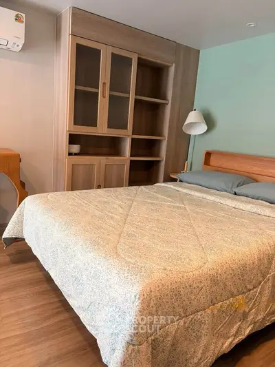Cozy bedroom with wooden furniture and modern decor