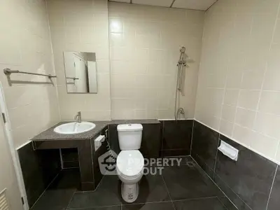 Modern bathroom with sleek fixtures and neutral tiles, perfect for a contemporary home.