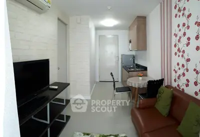 Modern living room with open kitchen, stylish decor, and cozy seating area.