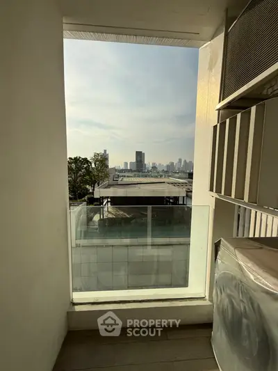 Stunning city view from a modern balcony with sleek design and ample natural light.