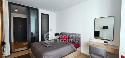 Modern bedroom with stylish decor and workspace in a contemporary apartment.