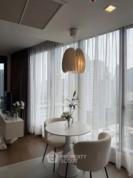 Modern dining area with city view, elegant lighting, and chic decor