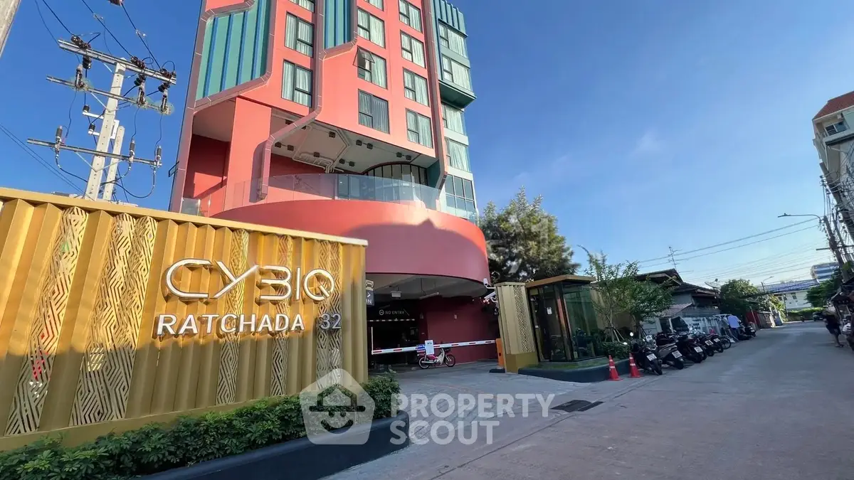 Modern building exterior with unique architecture and vibrant colors at CYBIQ Ratchada 32.