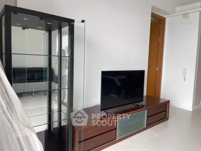 Modern living room with sleek TV stand and glass display cabinet, perfect for stylish urban living.