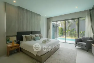 Luxurious bedroom with pool view in modern villa, featuring elegant decor and natural light.
