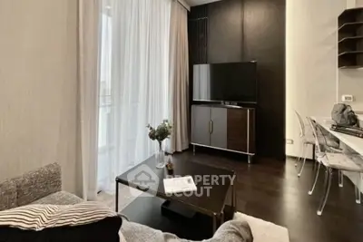 Modern living room with sleek furniture and large TV, perfect for relaxation and entertainment.