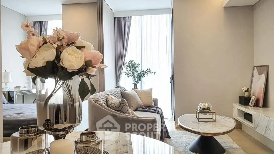 Elegant living room with modern decor and large windows, featuring a cozy seating area and stylish furnishings.
