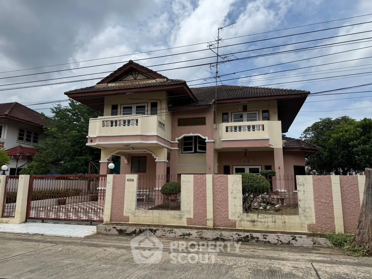 Charming two-story house with traditional architecture and spacious front yard in a serene neighborhood.