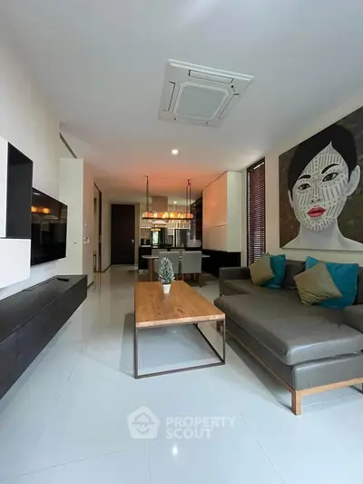 Modern living room with stylish decor and open layout, featuring a large sectional sofa and contemporary artwork.
