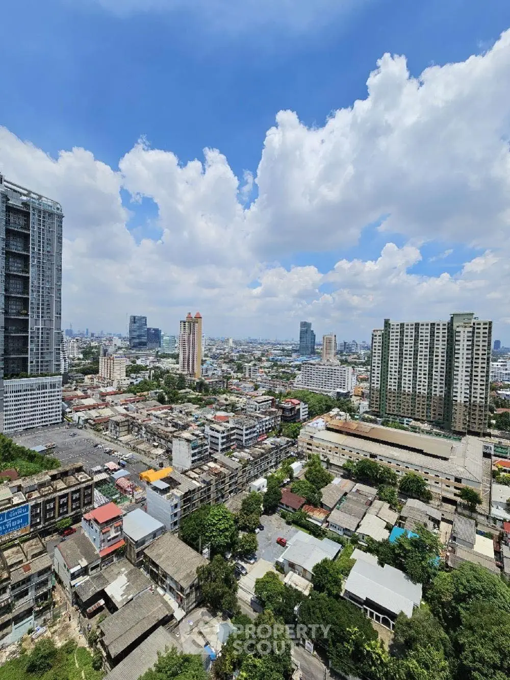 Stunning cityscape view from high-rise building showcasing urban skyline and clear blue sky.